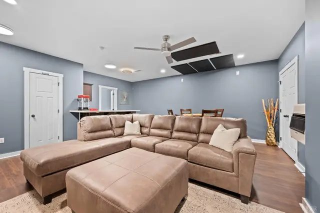 Basement family room with a sectional and ceiling fan at 2842 Chilton Road, Appomattox VA