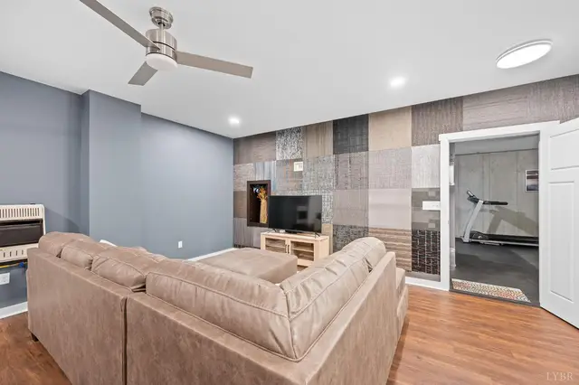 Basement family room with a textured accent wall at 2842 Chilton Road, Appomattox VA