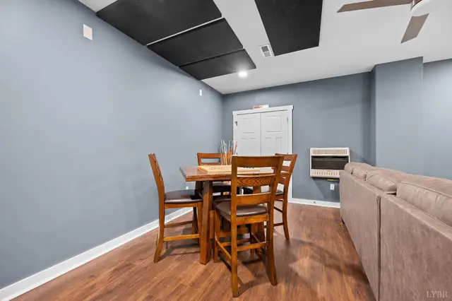 Basement dining area with a wood table and wall heater at 2842 Chilton Road, Appomattox VA