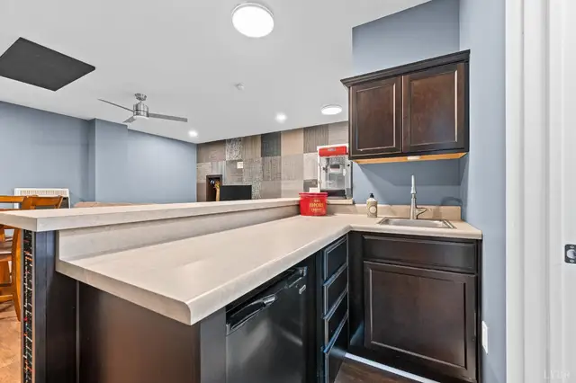 Basement wet bar with dark cabinets and a sink at 2842 Chilton Road, Appomattox VA