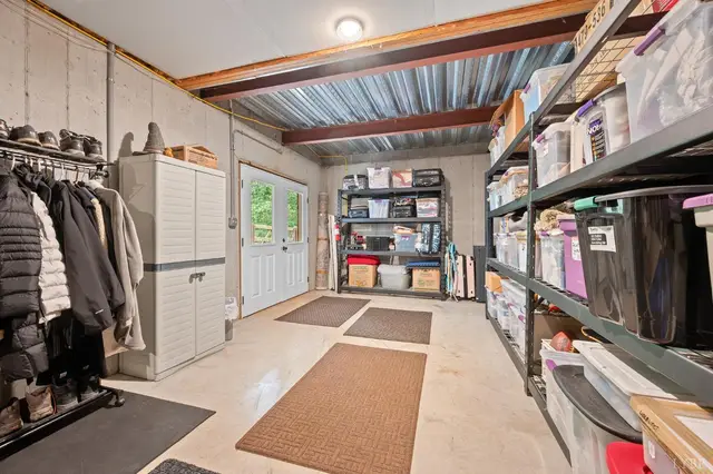 Basement storage room with metal shelving and a door to the outside at 2842 Chilton Road, Appomattox VA