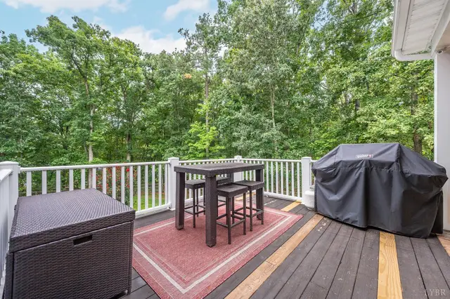 Deck with a high-top table and covered grill at 2842 Chilton Road, Appomattox VA