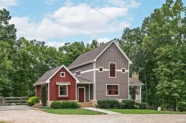 Front of the house with red and gray siding and a gravel drive at 2842 Chilton Road, Appomattox VA
