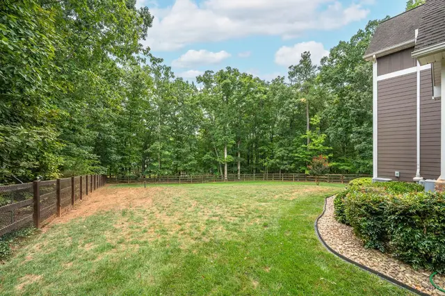 Backyard with a wood fence and wooded edge at 2842 Chilton Road, Appomattox VA
