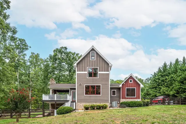 Back of the house with a deck and stone chimney at 2842 Chilton Road, Appomattox VA