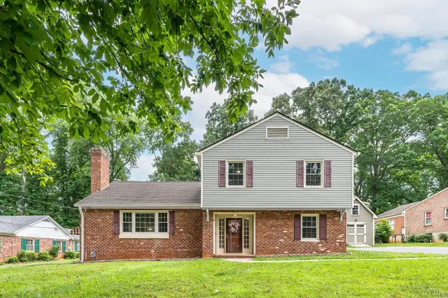 Front of the house, brick and siding split-level with a chimney at 3004 Ravenwood Drive, Lynchburg VA