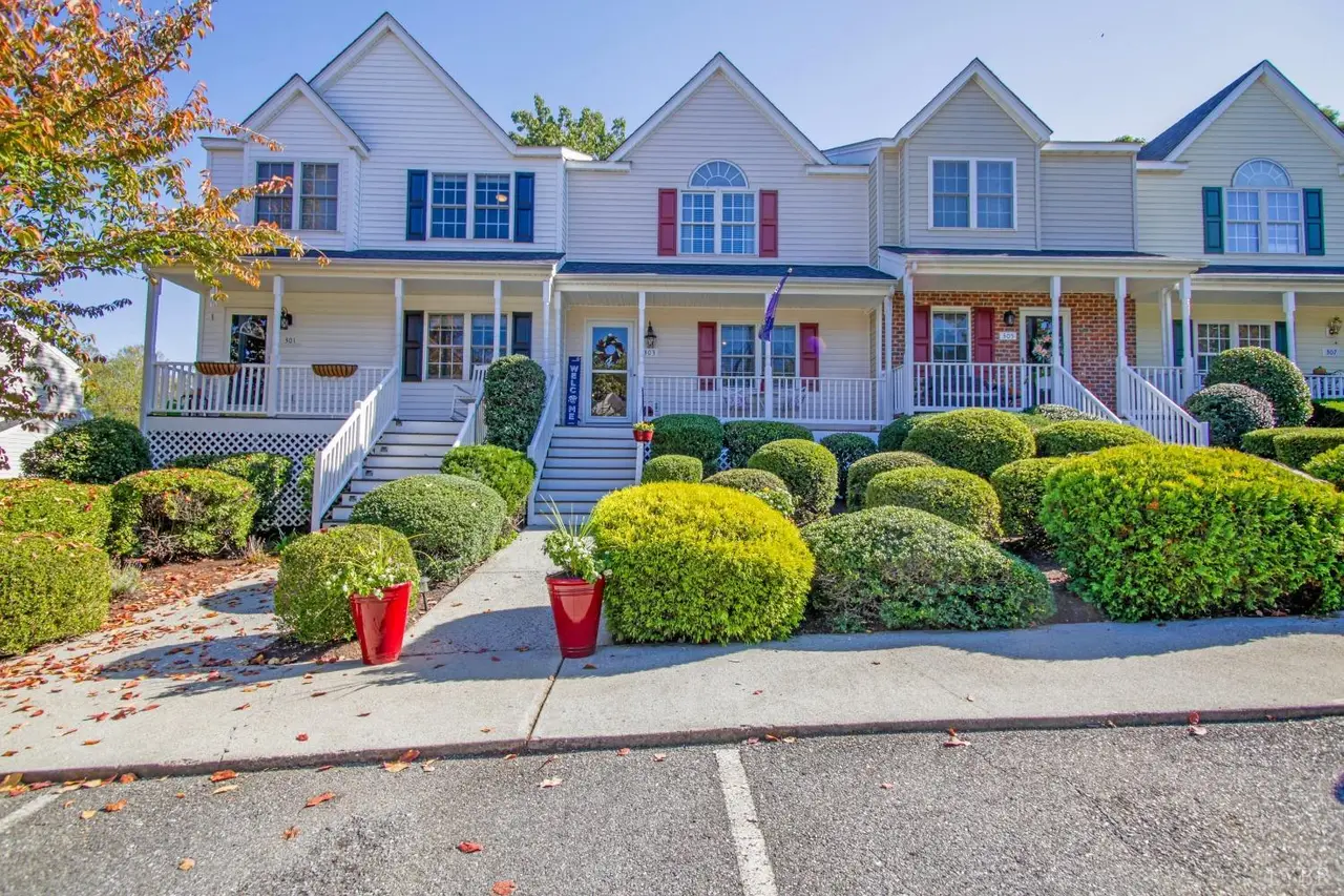 Front of the townhouses with front porches, steps and rounded shrubs at 303 Wexview Lane, Lynchburg VA