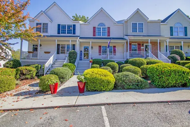 Front of the townhouses with front porches, steps and rounded shrubs at 303 Wexview Lane, Lynchburg VA