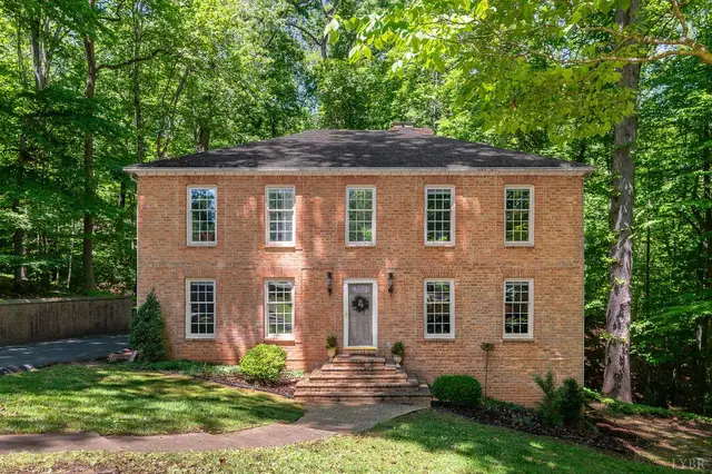 Front of the house, two-story brick with brick front steps on a wooded lot at 3108 Downing Drive, Lynchburg VA