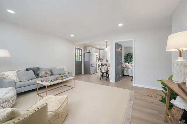 Living room with a gray sofa, open to the kitchen at 317 Warren Avenue, Lynchburg VA