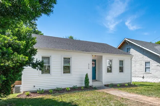 Front of the house, white one-story with a teal front door at 319 Warren Avenue, Lynchburg VA