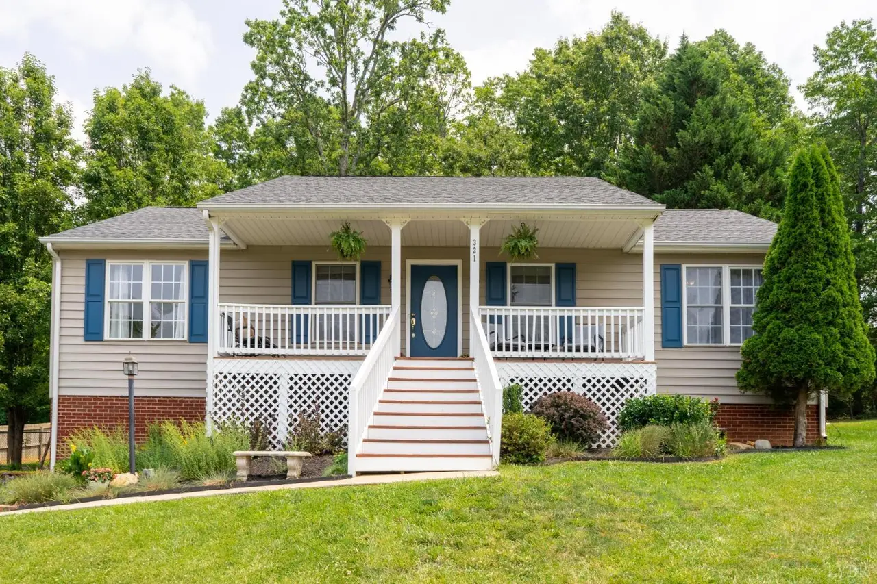 Front of the house with a covered front porch and blue shutters at 321 Smoketree Lane, Lynchburg VA