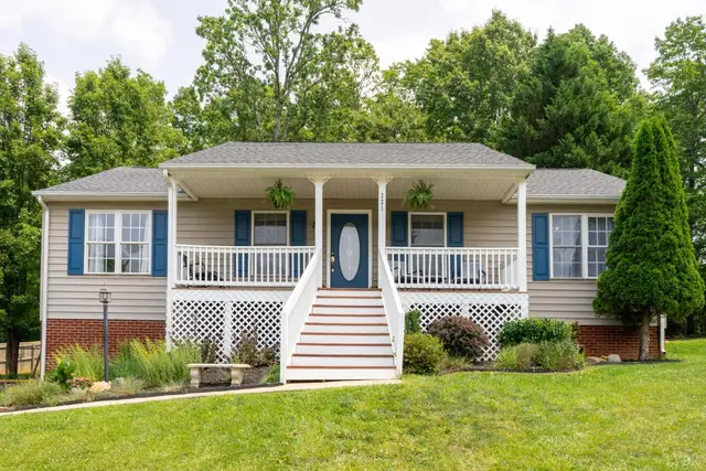 Front of the house with a covered front porch and blue shutters at 321 Smoketree Lane, Lynchburg VA