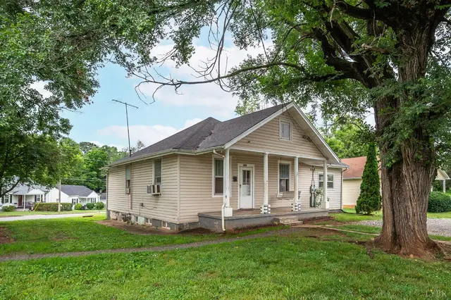 Side view of the house with a front porch under a large tree at 3243 Maryland Avenue, Lynchburg VA