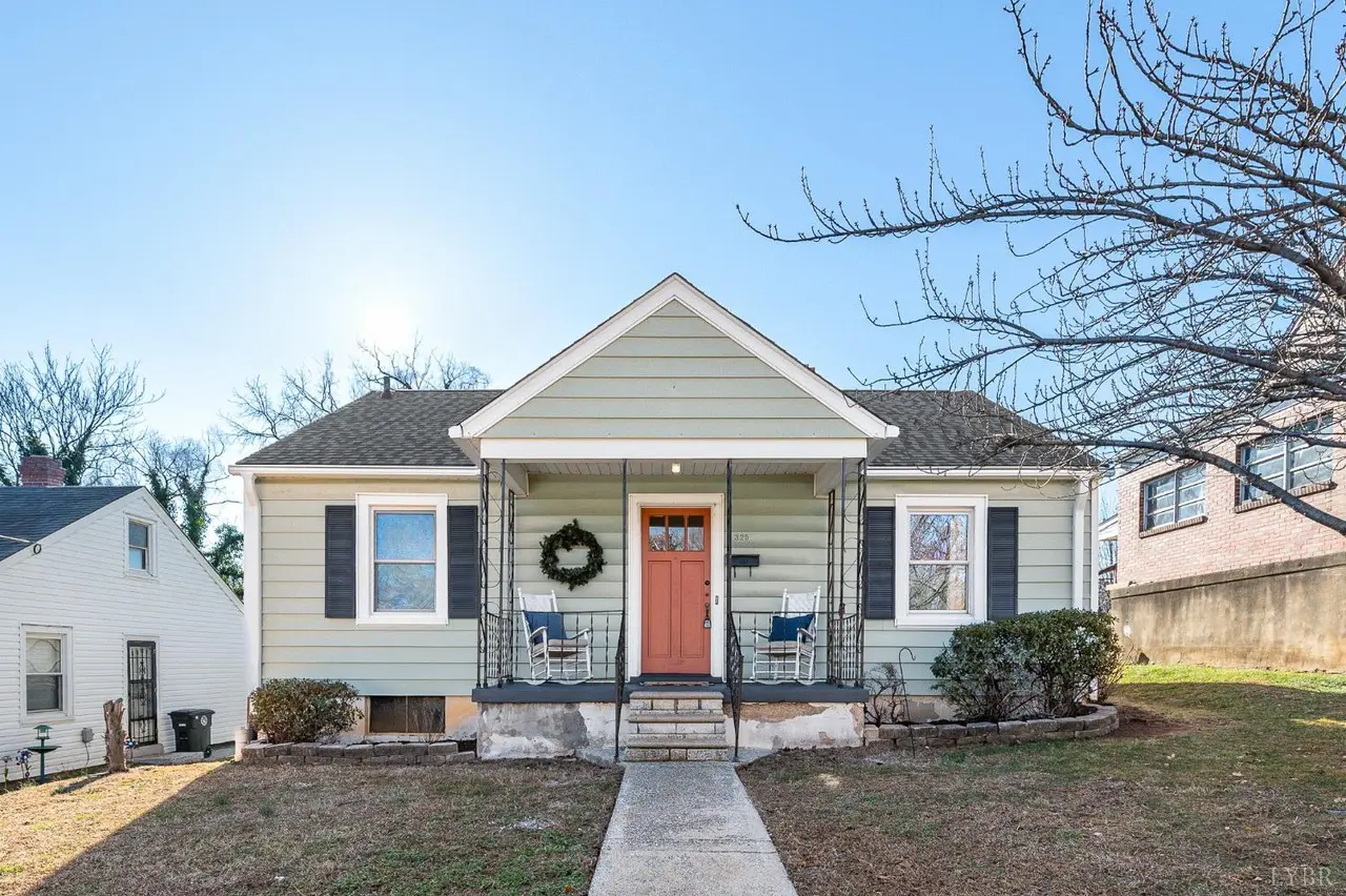 Front of the house with green siding and an orange door at 325 Saint Augustine Street, Lynchburg VA