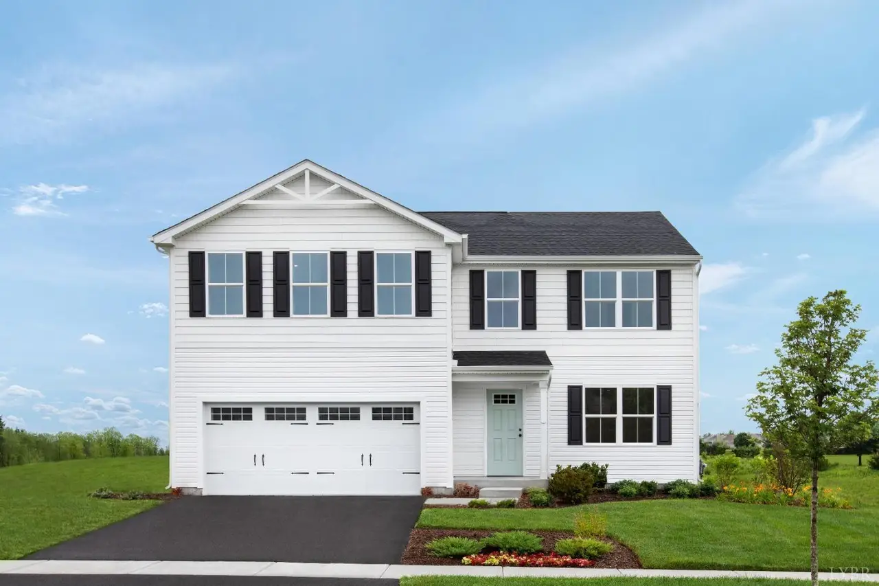 Front of the two-story house with white siding and a two-car garage at 33 Levi Lane, Lynchburg VA
