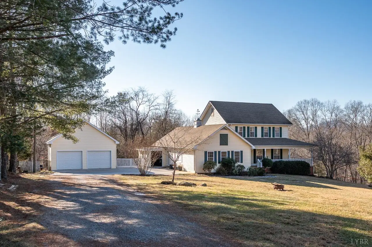 Front of the two-story house with a detached two-car garage at 3520 Roaring Run Road, Goode VA