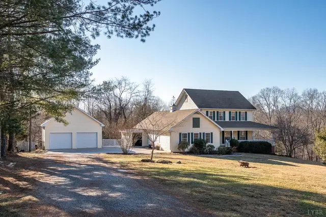 Front of the two-story house with a detached two-car garage at 3520 Roaring Run Road, Goode VA