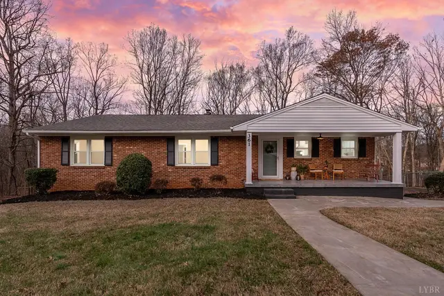 Front of the one-story brick house with a covered porch at sunset at 361 Woodhaven Drive, Lynchburg VA