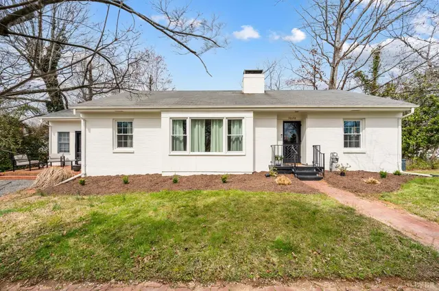 Front of the one-story white brick house with a brick walkway at 3620 E Woodside Avenue, Lynchburg VA