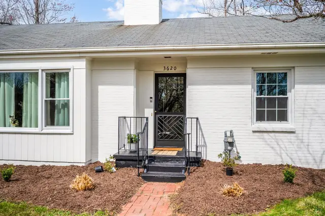 Front door with black metal steps and railings at 3620 E Woodside Avenue, Lynchburg VA