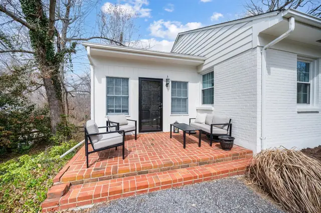 Brick patio with outdoor seating beside a side door at 3620 E Woodside Avenue, Lynchburg VA