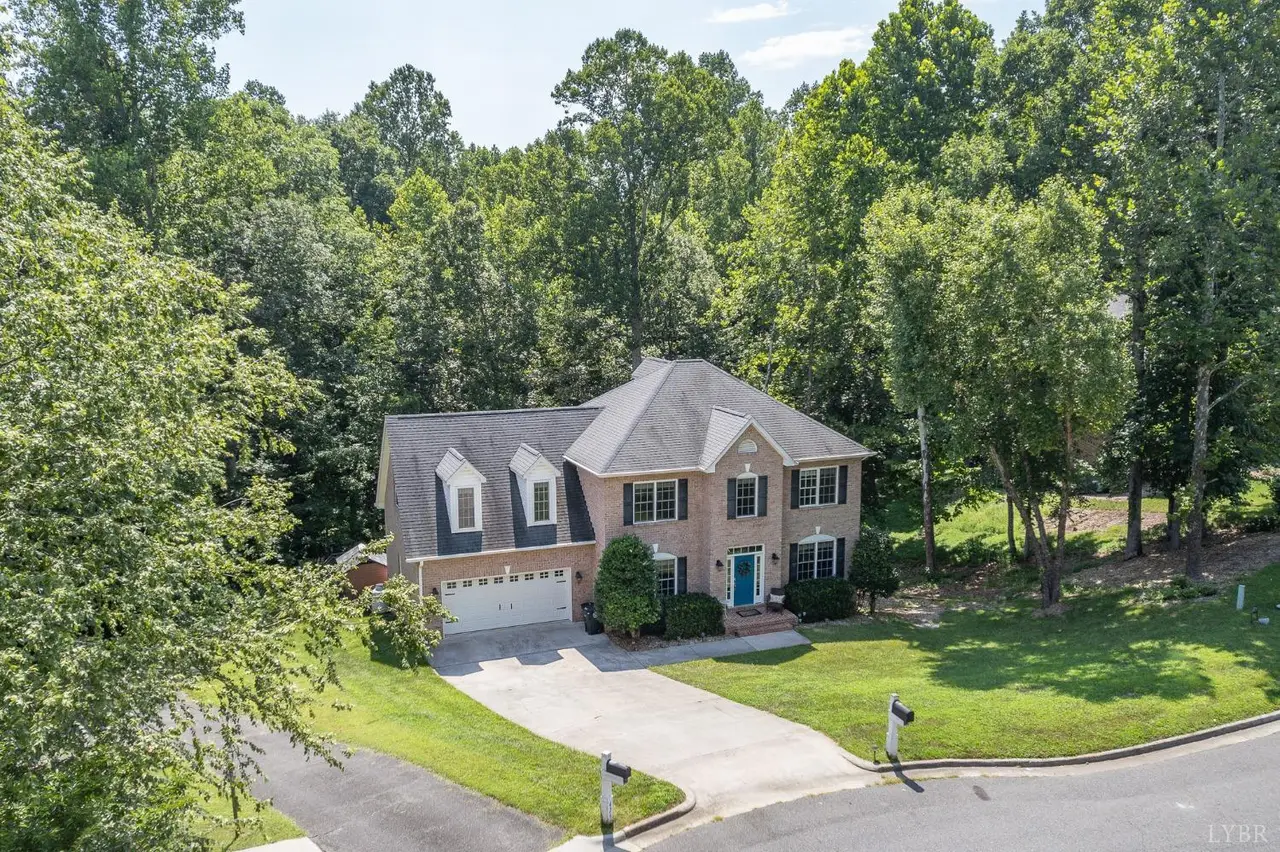 Aerial view of the two-story brick house and driveway at 421 Harvest Court, Lynchburg VA