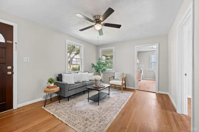 Living room by the front door with a gray sofa and wood floors at 4525 Brooklawn Circle, Lynchburg VA