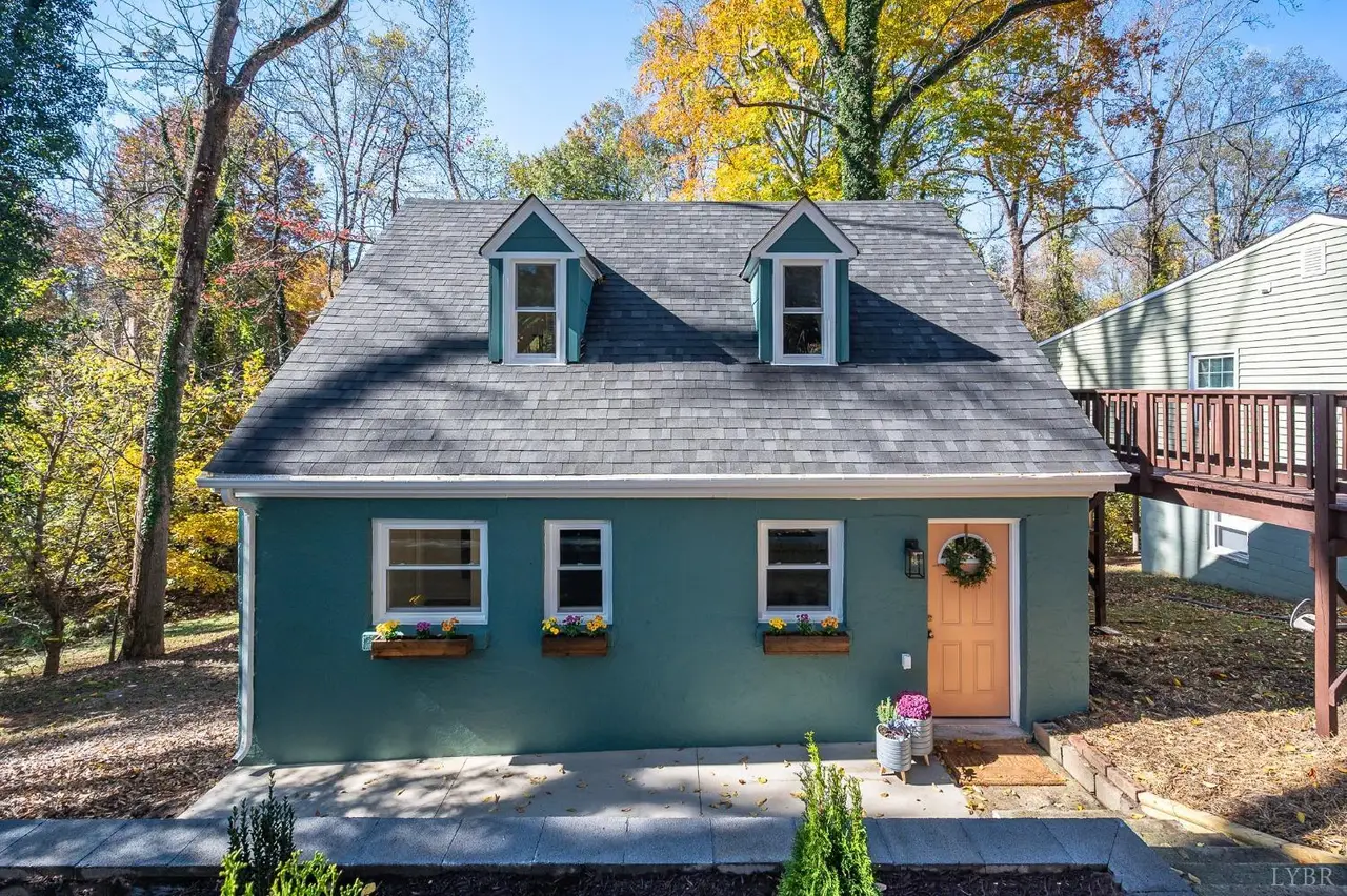 Front of the teal house with two dormers and an orange door at 50 W Princeton Circle, Lynchburg VA