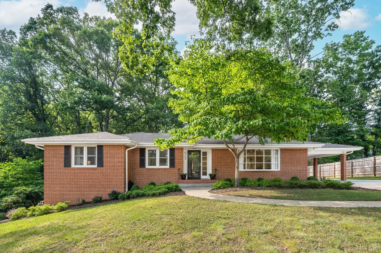 Front of the one-story brick house with a large shade tree at 5104 Wedgewood Road, Lynchburg VA