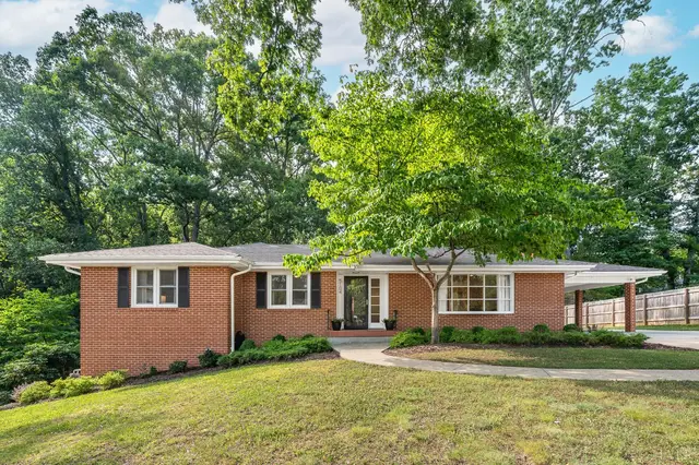 Front of the one-story brick house with a large shade tree at 5104 Wedgewood Road, Lynchburg VA
