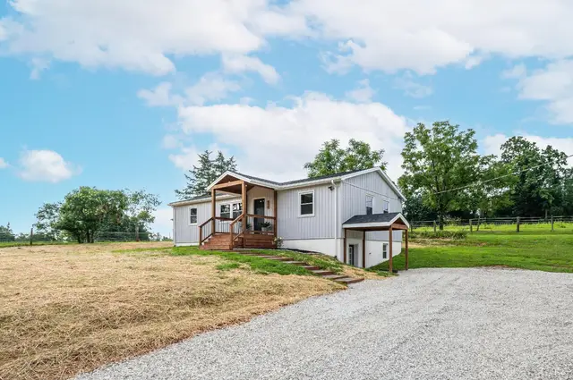 Front of the house with white siding and a gravel driveway at 519 E Monitor Road, Amherst VA