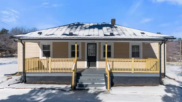 Front of the house with a metal roof and wood porch railing at 533 Patterson, Appomattox VA
