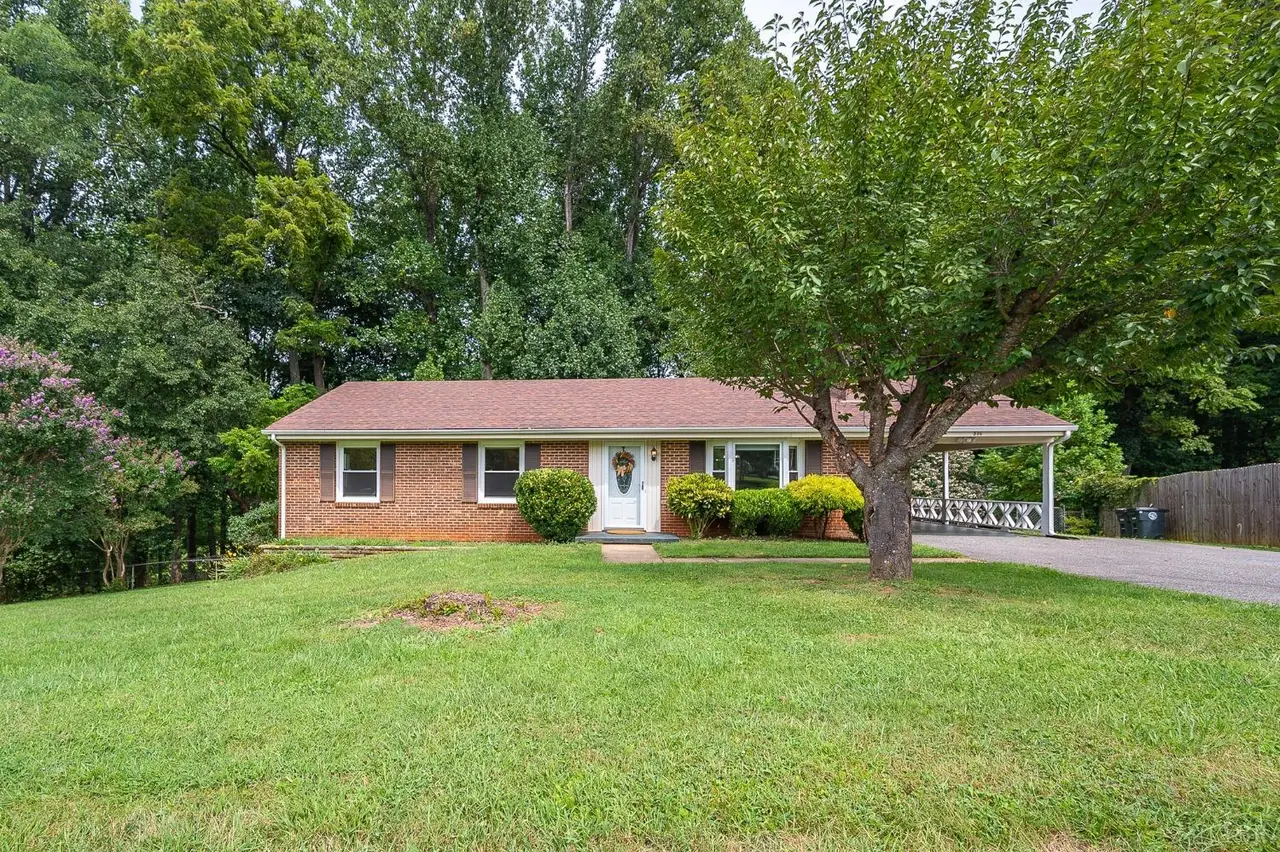 Front of the one-story brick house with a carport and large lawn at 536 Savannah Avenue, Lynchburg VA