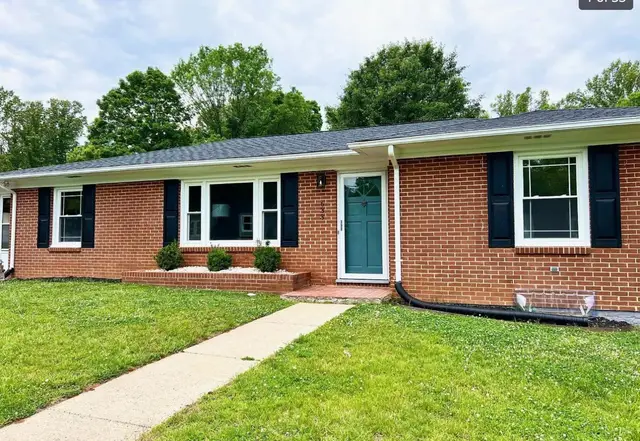Front of the one-story brick house with a teal front door at 633 Selene St. Street, Lynchburg VA