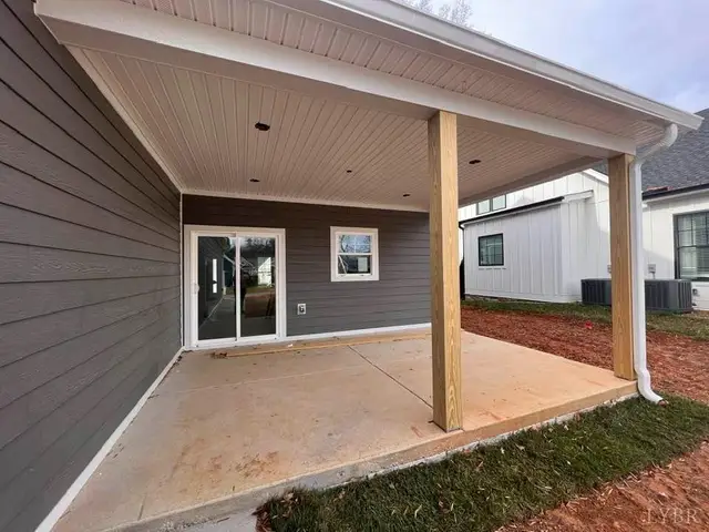 Covered back porch with a concrete floor and wood posts at 710 Elmwood Avenue, Lynchburg VA