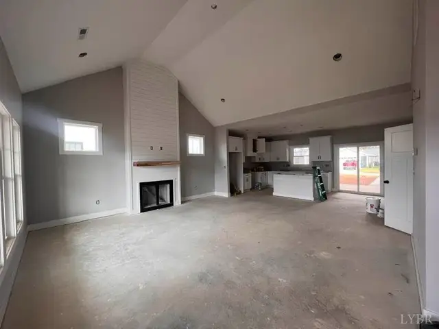 Unfinished living area with a vaulted ceiling and fireplace at 710 Elmwood Avenue, Lynchburg VA