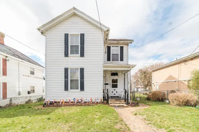 Front of the two-story white house with black shutters at 711 Norwood Street, Lynchburg VA