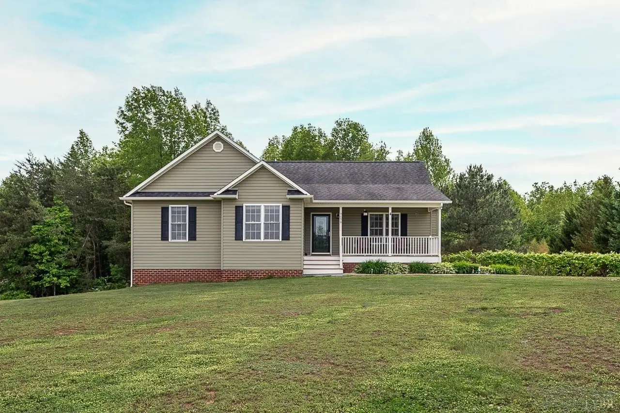 Front of the house with tan siding and a covered front porch at 7179 Stage Road, Concord VA