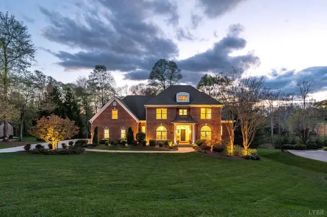 Straight on front view of the brick house with landscape lighting at 1278 Jefferson Dr W, Forest VA