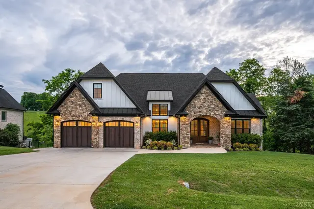 Front of the house with stone and siding and a two-car garage at 1836 Lake Manor Drive, Forest VA