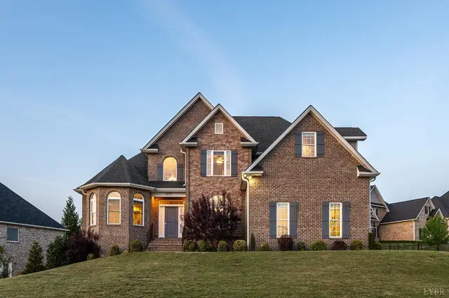 Front of the two-story brick house with gray shutters at 2220 Colby Drive, Forest VA