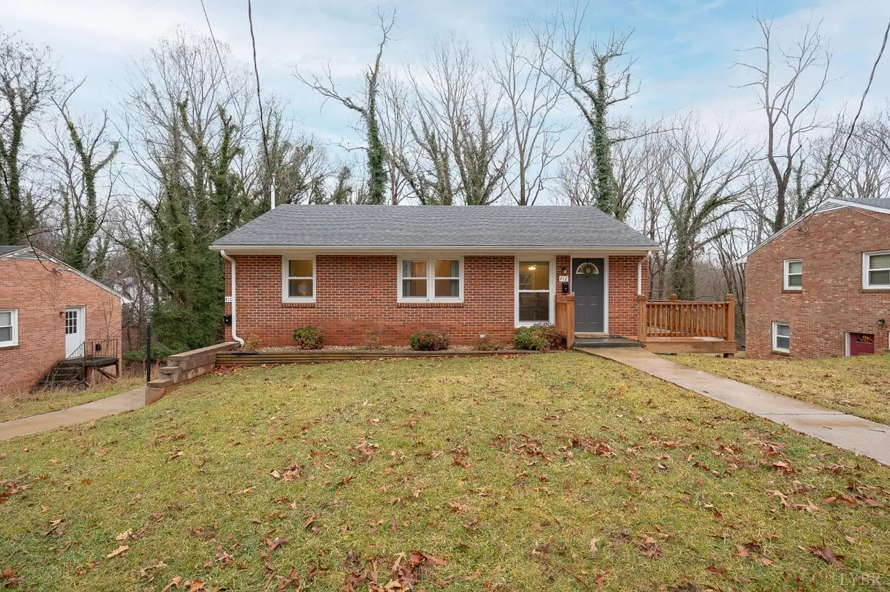 Front of the one-story brick house with a wood deck at the entry at 412 Belvedere Street, Lynchburg VA
