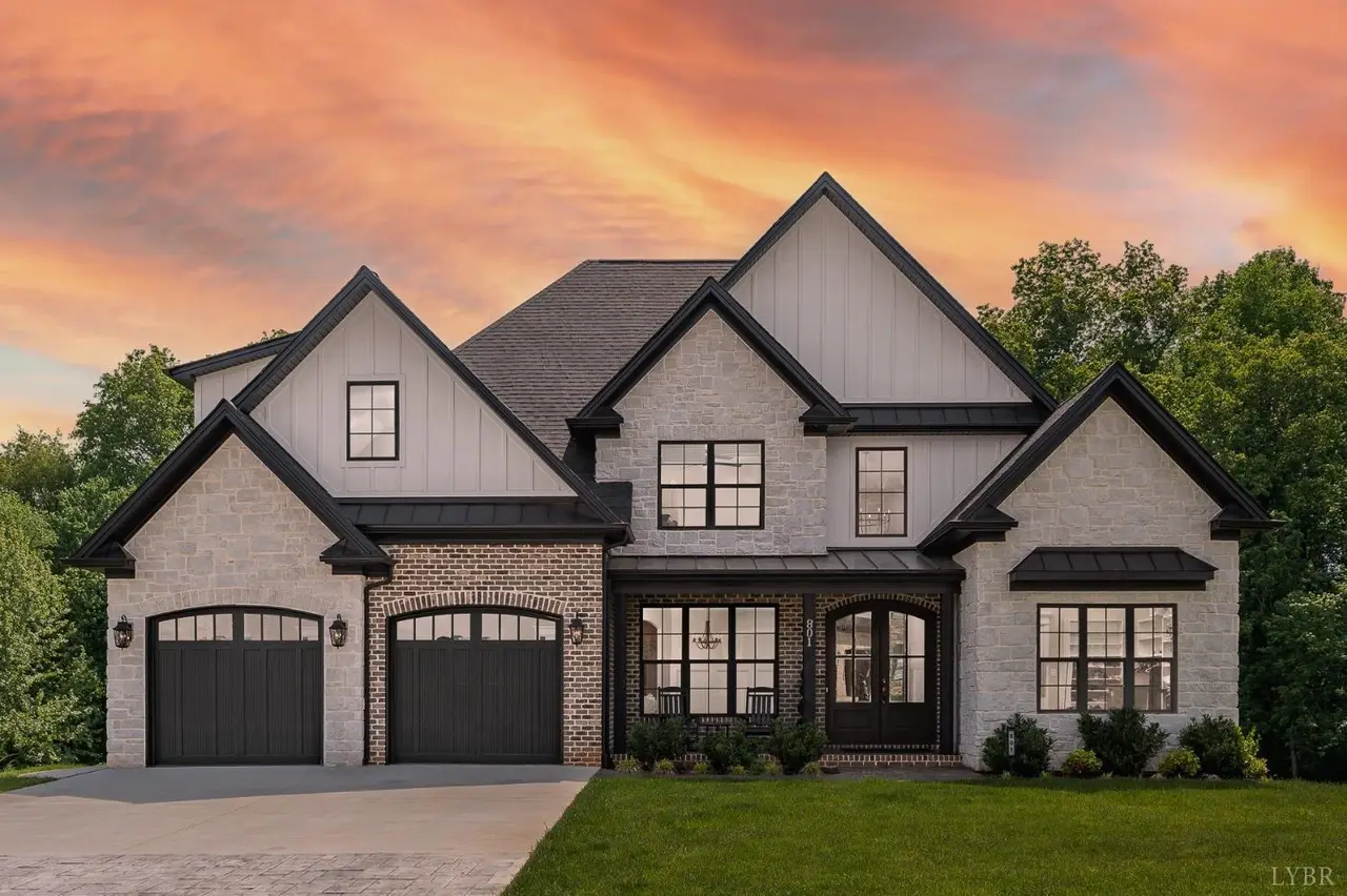 Front of the brick house with a two-car garage at sunset at 801 Leander Drive, Forest VA