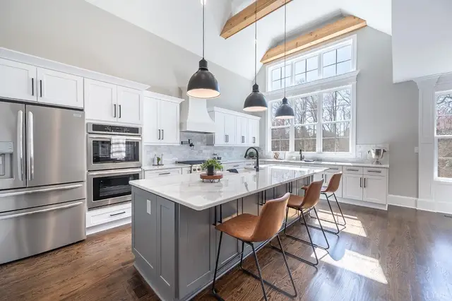 Kitchen with a gray island, pendant lights and stainless appliances at 801 Leander Drive, Forest VA
