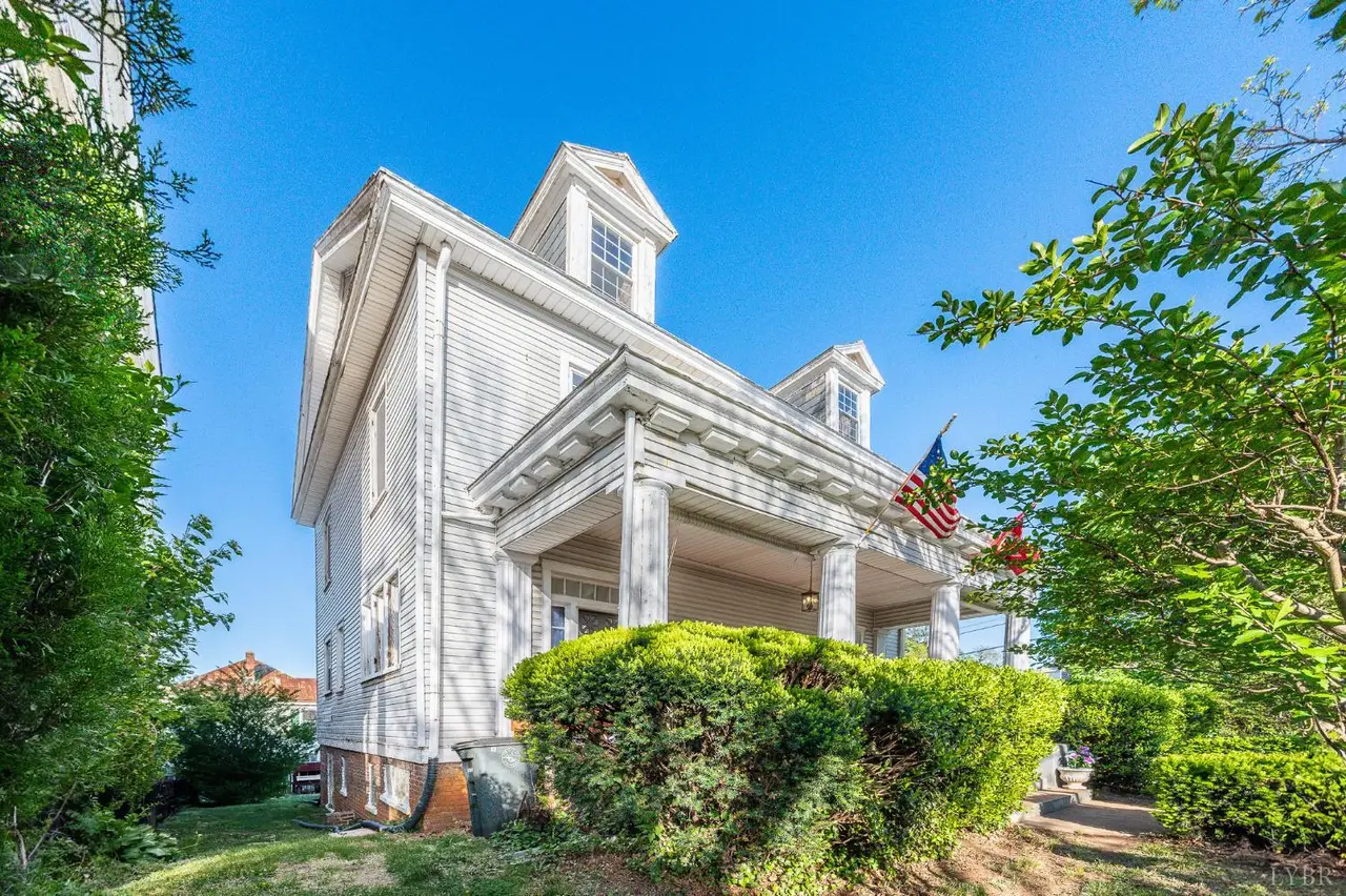 Front of the white house with dormers and a covered porch at 824 Floyd Street, Lynchburg VA