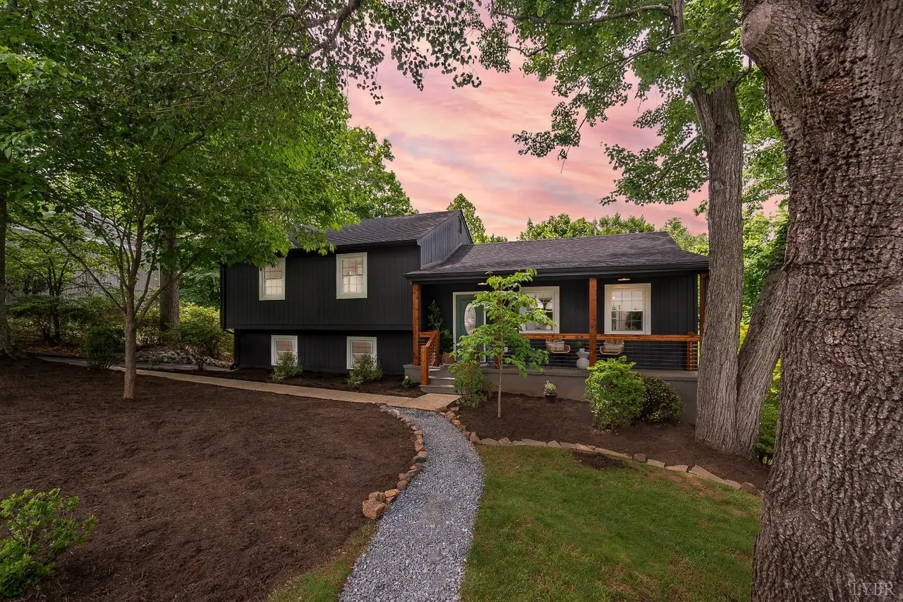 Front of the dark painted house with a gravel path at sunset at 915 Rothowood Road, Lynchburg VA