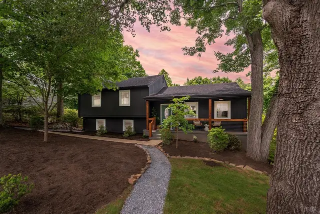 Front of the dark painted house with a gravel path at sunset at 915 Rothowood Road, Lynchburg VA